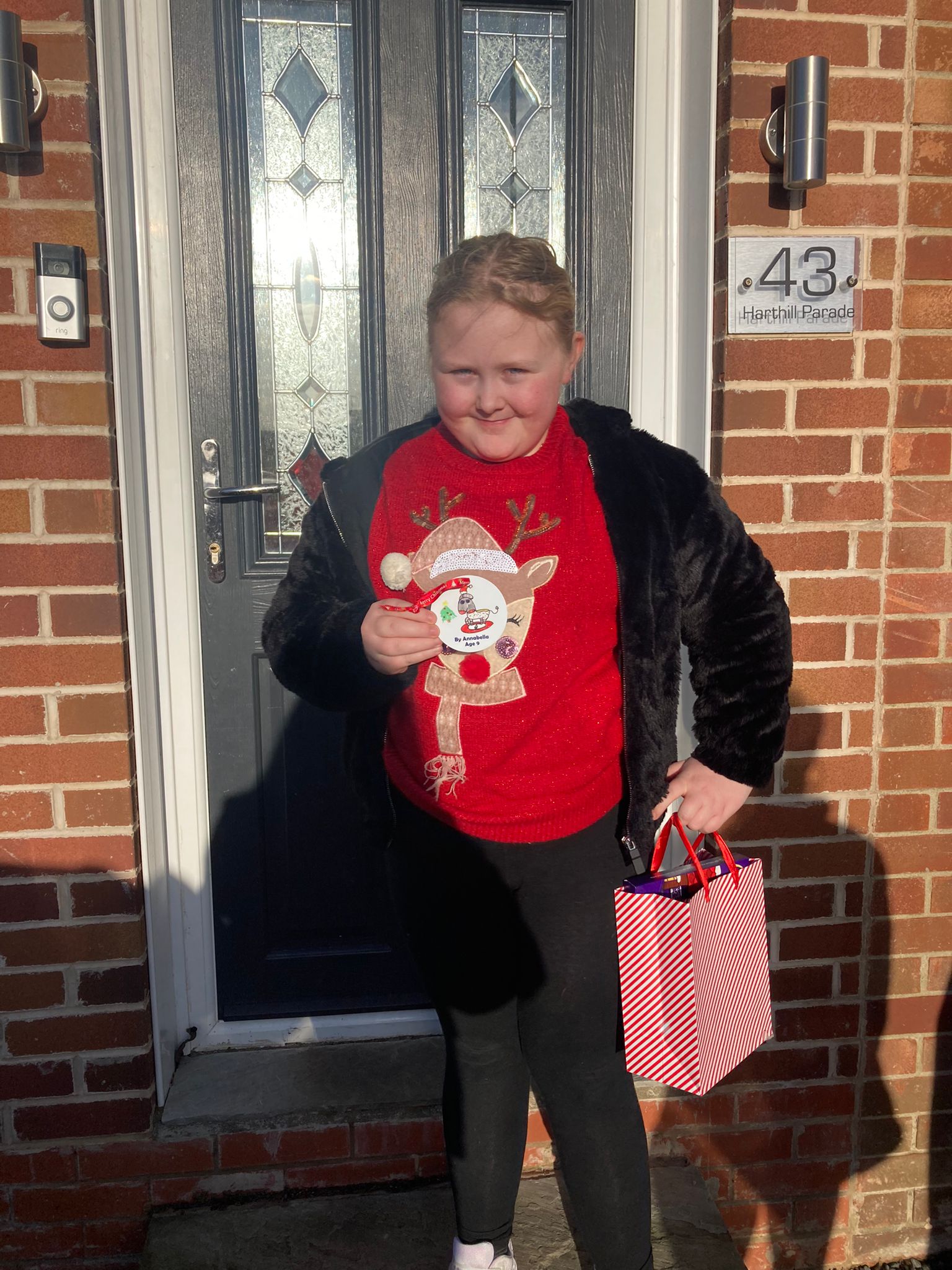 Photo of prize winner with their bauble and a gift