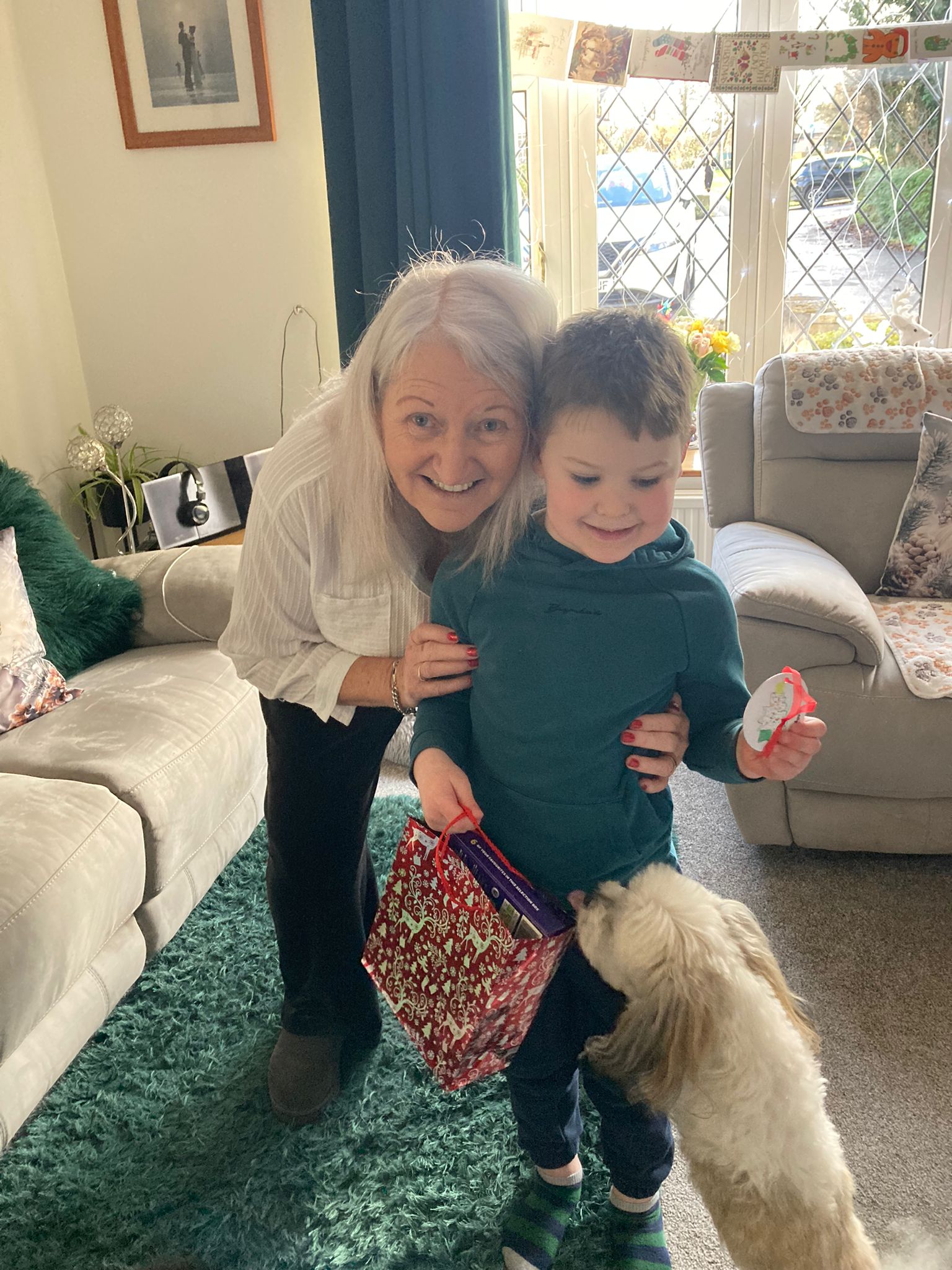 Photo of prize winner with their bauble and a gift